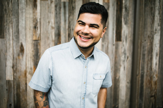 Portrait of Happy young hispanic - latino man in city