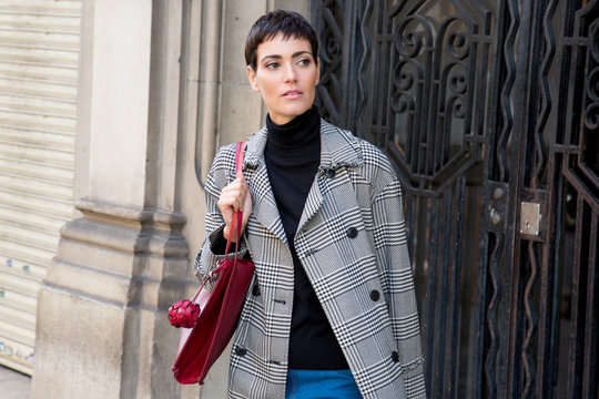 Stylish short haired business woman commuting between meetings on a busy city