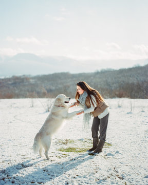 Woman playing with dog in winter