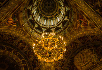 Majestic chandelier and wall murals. Internal design of the ancient Orthodox church