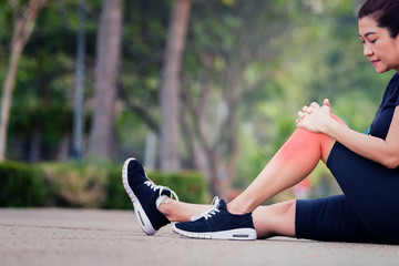 Asian woman runner holding her sports injured leg,exercise and healthy concept. - 209170751
