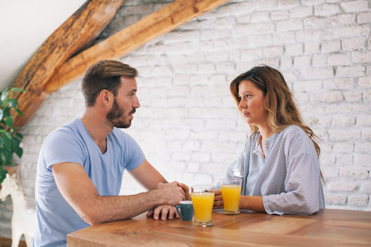 Married Couple Talking In The Kitchen