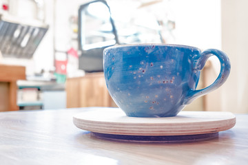 Blue Cup with tea or coffee on the stand