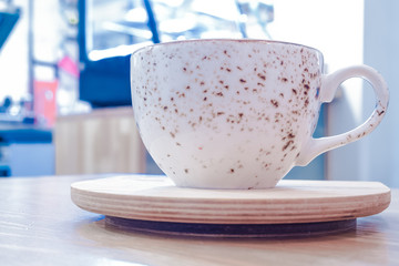White Cup with tea or coffee on the stand