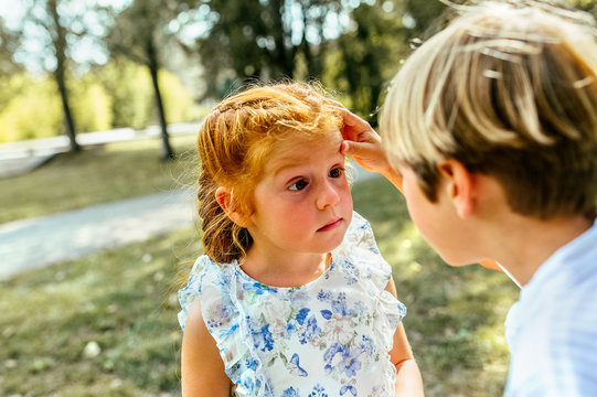 Kid looking at his sister's eyes