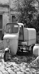 old three-wheeled motorcycle in the historic center of nardò itala