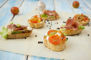 sandwiches with soft cheese, meat and tomatoes