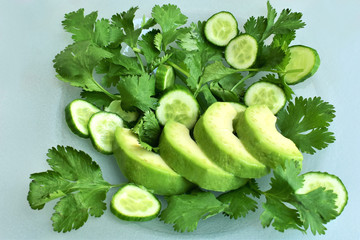 Avocado green salad with fresh cucumber and arugula, natural healthy food.