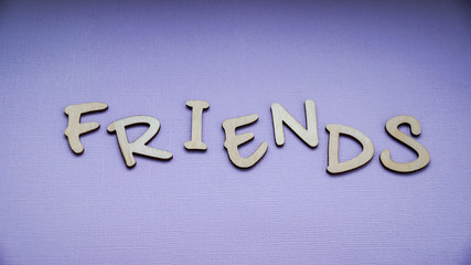 Message friends of wooden blocks on a purple color background.