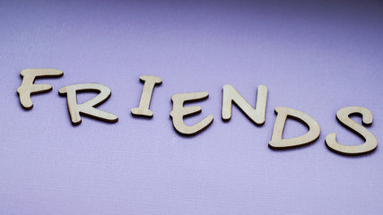 Message friends of wooden blocks on a purple color background.