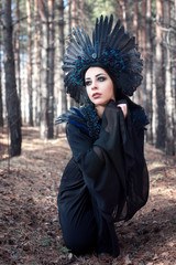 Portrait of a beautiful mysterious woman in the forest