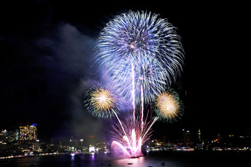 Obraz na płótnie Canvas Festive beautiful colorful fireworks display on the sea beach, Amazing holiday fireworks party or any celebration event in the dark sky
