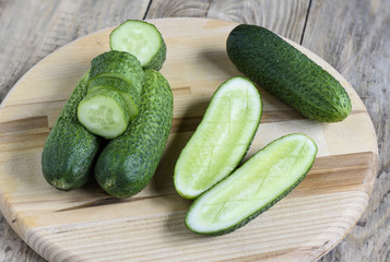 Fresh cucumbers, halves of cucumbers and slices of cucumber
