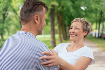 Obraz premium Happy attractive woman hugging her husband