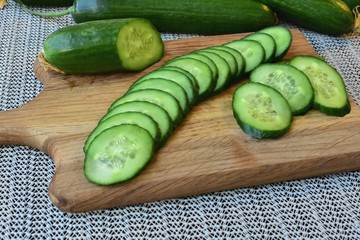 Fresh cucumber sliced on a cutting board.