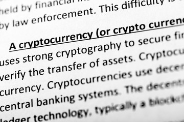 Cryptocurrency explanation or description in dictionary or article. Close up with focus on cryptocurrency.