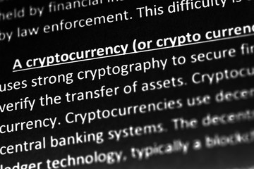 Cryptocurrency explanation or description in dictionary or article. Close up with focus on cryptocurrency.