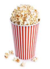 Popcorn in striped bucket isolated on a white background.