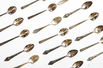 Vintage spoons, silverware pattern on white background. Kitchen texture. Top view.