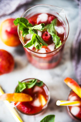 Light summer refreshing drink with fruits and berries - sangria. In glasses on a gray table. Top view, flat lay