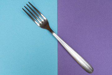 a fork on a two colored surface