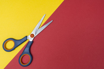 a pair of scissors on a colored surface