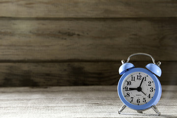 blue alarm clock on wood background
