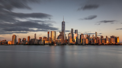 New york city skyline daytime sun clouds blue golden hour