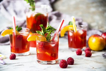 Light summer refreshing drink with fruits and berries - sangria. In glasses on a gray table