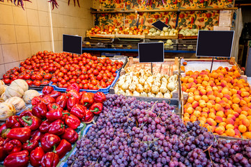 Counter filled with various vegetables and fruits in the great market hall in Budapest