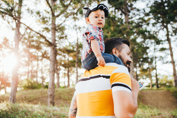 Fototapeta premium The hipster's father is playing with his little son.