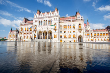 Fototapeta premium View on the main fasade of the famous Parliament building with reflection in the water during the morning light in Budapest, Hungary