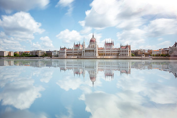 View on the riverside with Parliament building during the daylight in Budapest city. Long exposure image technic - obrazy, fototapety, plakaty