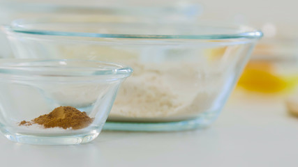 Glass bowls with spices ingredients for cooking biscuits