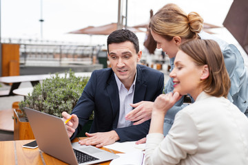 White collar. Experienced white collar worker feeling curious while explaining actively future work plan to his colleagues