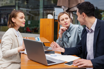 Career women. Two successful career women feeling motivated while listening to their clever chef