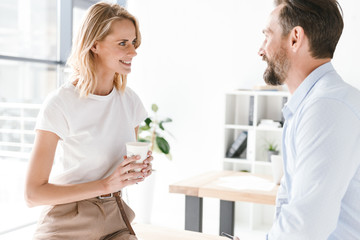 Fototapeta premium Couple of young colleagues talking