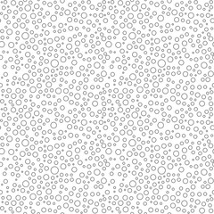 Seamless background with random round black elements. Abstract ornament. Dotted abstract pattern