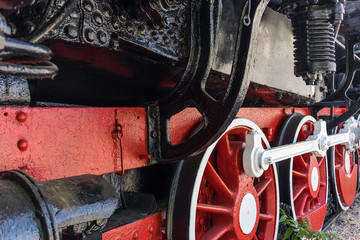 Fragment of the locomotive on the rails close up