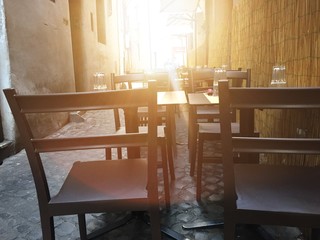 chairs and table of a street restaurant in Rome