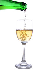 white wine pouring in glass on white background