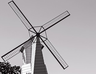 Fototapeta premium Black windmill against on sky in monochrome tone