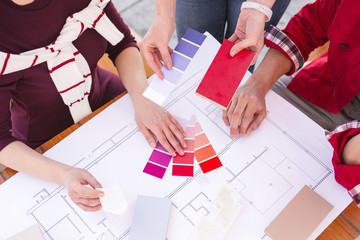 Color palette. Young married couple feeling curious while choosing color palette for their future...