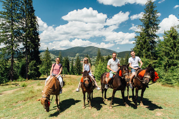 Fototapeta na wymiar group of people riding horses in the mountains