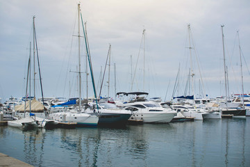 Fototapeta na wymiar Abstract blur yachts in port background.