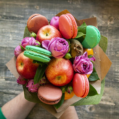 composition of ripe fruit, rose and macaroon