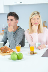 Obraz na płótnie Canvas Couple at breakfast ignoring each other