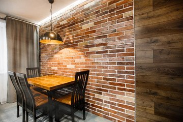 Dark brown modern kitchen interior. Brick wall and ceiling lamp, Grunge retro vintage interior