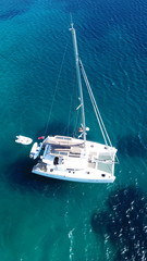 Aerial drone bird's eye view photo from luxury Catamaran docked at tropical deep waters 