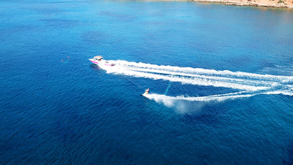 Naklejka premium Aerial drone bird's eye view photo of man practicing water ski in tropical beach